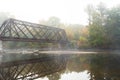 Abandoned train bridge in New Hampshire, foggy river