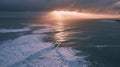 Moody Aerial Landscape Depict a dramatic aerial view of a vast coastline during a stormy sunset