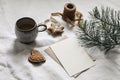 Moody Christmas stationery. Winter blank greeting card, invitation mockup. White linen tablecloth. Green pine tree