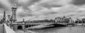 Moody panoramic cityscape with Pont Alexandre III bridge and Seine river in Paris, France in black and white Royalty Free Stock Photo