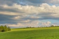 Moody cloudy sky over green hills