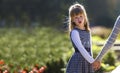 Moody cute child girl holding mother hand looking back on warm day outdoors. Family relationship and recreation Royalty Free Stock Photo