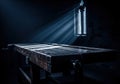 Moody dark wooden workbench illuminated by dramatic light ray from gothic window Royalty Free Stock Photo