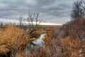 Moody dramatic autumn river landscape. Dramatic cloudscape