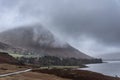 Moody dramatic Winter foggy landscape image of Wast Water in English Lake District with thick fog blocking view of mountains in Royalty Free Stock Photo