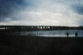 A moody dream like concept of a bridge going over water. on a winters evening. With a grunge, artistic, edit Royalty Free Stock Photo