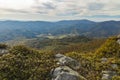 Moody foggy mountain top view highland rocky landscape in autumn season cloudy day time stones ground foreground and plateau