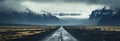 Moody Icelandic landscape: An asphalt road crosses a stormy mountain backdrop