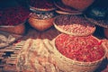 Moody image of colored spices at local market