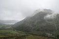 Moody landscape image of low cloud hanging over Snowdonia mountain range after heavy rainfall in Autumn with misty weather Royalty Free Stock Photo