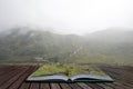 Moody landscape image of low cloud hanging over Snowdonia mountain range after heavy rainfall in Autumn with misty weather Royalty Free Stock Photo