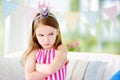 Moody little girl wearing princess tiara feeling angry and unsatisfied Royalty Free Stock Photo