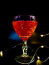 Moody and Mysterious: Red Fluid in a Glass on a Black Background with Ambient Lighting