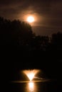 Moody Orange Full Moon Over Pond With Fountain Royalty Free Stock Photo