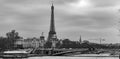 Moody panoramic cityscape with Pont Alexandre III bridge, Seine river and Eiffel Tower in Paris, France in black and white Royalty Free Stock Photo