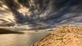 Moody skies over the lighthouse at Ile Rousse in Corsica Royalty Free Stock Photo