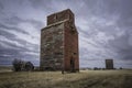 Moody skies over two old grain elevators in Neidpath, Saskatchewan, Canada Royalty Free Stock Photo
