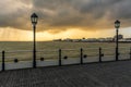 A moody sky starts to block the sunset glow over the seafront of Worthing, Sussex, UK