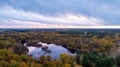 Moody sunset clouds over a forest in the fall Royalty Free Stock Photo