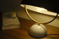 Moody table with retro lamp and a stack of books