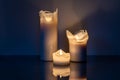 Moody view of three white candles