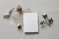 Moody wedding styled composition. Feminine desktop mockup scene with white rose flowers and leaves, silk ribbon, craft