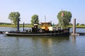 View on old antique wood ship on river maas in dutch countryside