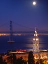 The moon above Ferry Building & Bay Bridge Royalty Free Stock Photo