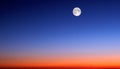 The moon against the background of the evening sky.