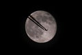 The moon and an airplane in the night sky. Royalty Free Stock Photo