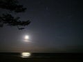 Moon and auriga constellation stars on night sky