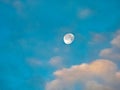 The moon in the blue with clouds. Two quarters of the lunar Royalty Free Stock Photo