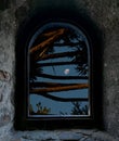 The moon in a blue sky from an old stone window Royalty Free Stock Photo