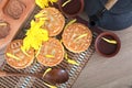 Moon cakes and a pot of tea and moon cake molds and golden chrysanthemums placed on the table.Chinese characters on the moon cake