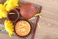 Moon cakes, tea and golden chrysanthemums for the Chinese Mid-Autumn Festival.Chinese characters on the moon cake means `Five kind