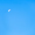 Moon in clear blue autumn morning sky