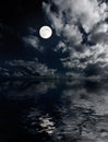 Moon and clouds above sea at night Royalty Free Stock Photo