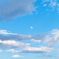 Moon and clouds in blue evening sky Royalty Free Stock Photo