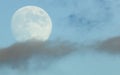 Moon with clouds on a blue gloomy sky, close-up. Beautiful background, beautiful landscape Royalty Free Stock Photo