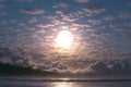 Moon and clouds create captivating atmosphere above serene ocean