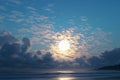 Moon and clouds create captivating atmosphere above serene ocean