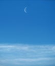 Moon and clouds observing on blue ksy Royalty Free Stock Photo