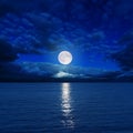 Moon in clouds over river Royalty Free Stock Photo