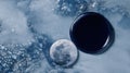 Moon and Black Liquid Disc Lying on a Textured Blue Surface Creating a Celestial and Otherworldly Ambiance Royalty Free Stock Photo