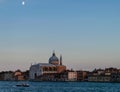 The moon at dusk over Church of the Santissimo Redentore across the Giudecca Canal