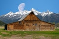 Moon going down over the Grand Tetons behind the T.A. Moulton barn on Mormon Row Royalty Free Stock Photo