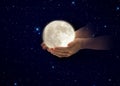 Moon in hands on front blue cloudy sky hold peace concept natire background