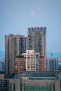 The full moon hangs over the city before sunrise Chongqing China