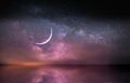 Moon on lilac blue dark starry sky at night at sea water wave reflection nebula milky way cosmic background