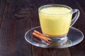 Moon milk with turmeric in a glass cup, horizontal, copy space Royalty Free Stock Photo